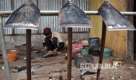 Perajin memproduksi cangkul di salah satu rumah industri di Ambarawa, Kabupaten Semarang, Jawa Tengah, Rabu (10/1). Alat pertanian dan alat pertukangan, seperti cangkul dan sabit hasil produksi perajin setempat dipasarkan seharga Rp100.000 -Rp250.000 per unit ke sejumlah daerah. 