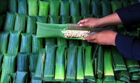 Perajin menyelesaikan pembuatan tempe menggunakan daun pisang di Gintangan, Banyuwangi, Jawa Timur.