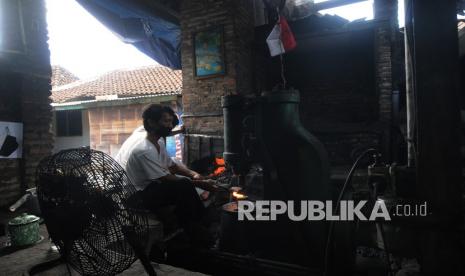 Perajin pandai besi menatah besi dengan alat modern saat membuat arit di Sorotakan Ngledok, Segaran, Delanggu, Klaten, Jawa Tengah, Senin (13/9/2021). Generasi perajin pandai besi saat ini memanfaatkan mesin modern dalam proses pembuatan kerajinan arit, golok, dan pisau yang dijual dari harga Rp30 ribu hingga Rp300 ribu tergantung jenis dan kualitasnya. 