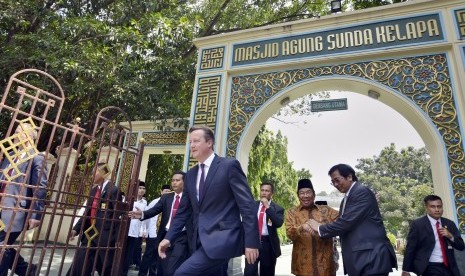 Perdana Menteri Inggris David Cameron (tengah) didampingi Dubes RI untuk Inggris Hamzah Thayeb (kedua kanan) dan Ketua Pengurus Masjid Agung Sunda Kelapa Aksa Mahmud (ketiga kanan) berjalan keluar seusai mengunjungi Masjid Agung Sunda Kelapa, Jakarta, Sela