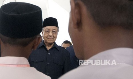 Perdana Menteri ke-7 Malaysia Tun Mahathir Mohamad (tengah) didamping jemaah berjalan seusai Salat Jumat di Masjid Negara, Kuala Lumpur, Malaysia, Jumat (11/5). 