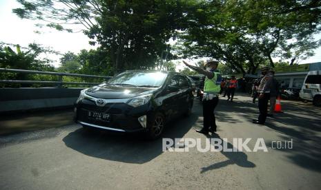 Personel kepolisian mengarahkan warga untuk berputar arah saat pengetatan mudik mulai diberlakukan (ilustrasi)