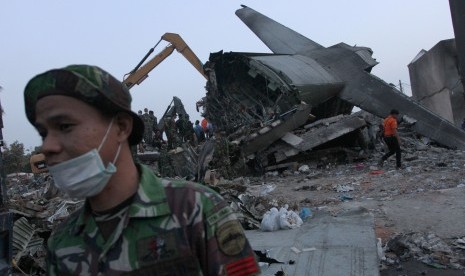 Personel TNI berada didekat ekor bangkai pesawat Hercules C-130 yang jatuh ketika akan dilakukan proses evakuasi, di Jalan Jamin Ginting, Medan, Sumatera Utara, Rabu (1/7).