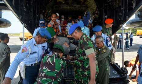 Personel TNI membawa korban luka bencana gempa dan tsunami Palu dan Donggala, Sulawesi Tengah setibanya di Base Ops Lanudal Juanda, Sidoarjo, Jawa Timur, Kamis (4/10). 