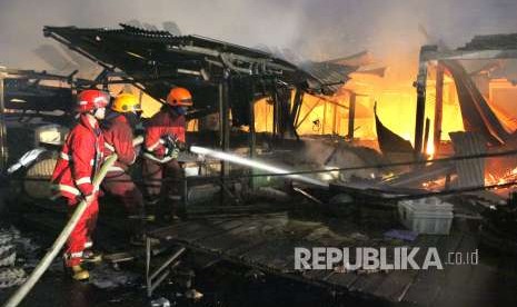 Pertugas pemadam kebakaran berusaha memadamkan api yang menghanguskan Pasar Gedebage, Kota Bandung, Senin (3/9).