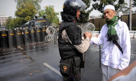   Perwakilan pengunjuk rasa dan petugas kepolisian melakukan negosiasi saat aksi unjuk rasa mengecam film anti Islam di depan Kedubes Amerika Serikat, Jakarta, Senin (17/9). (Aditya Pradana Putra/Republika)