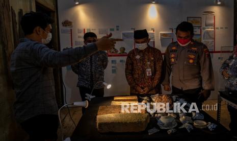 Perwakilan Yayasan Lasem Heritage (YLH) Abdul Salam (kiri) menjelaskan tentang sejumlah koleksi artefak Lasem kepada Kepala Dinas Kebudayan dan Pariwisata Kabupaten Rembang Mutaqin (kedua kanan) saat pembukaan pameran bertajuk Rentang Kronika Lasem Rembang di Museum Nyah Lasem, Karangturi, Kabupaten Rembang Jawa Tengah, Selasa (25/1/2022). Pameran yang menampilkan artefak dan koleksi masa prasejarah Situs Prasejarah Plawangan Lasem tahun 2500 SM, peta-peta kuno serta foto perubahan wajah Lasem masa kolonial hingga 2022 itu akan berlangsung hingga 28 Februari, 2022 mendatang. 