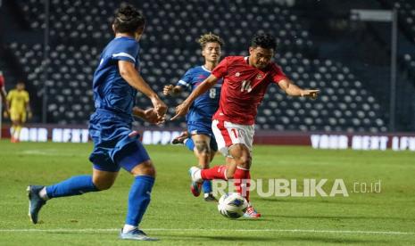 Pesepak bola Indonesia Asnawi Mangkualam (kanan) mencoba melewati dua pesepak bola Taiwan pada babak Play-off Kualifikasi Piala Asia 2023 di Stadion Chang Arena Buriram, Thailand, Kamis (7/10/2021). Timnas Indonesia menang 2-1 atas Taiwan.