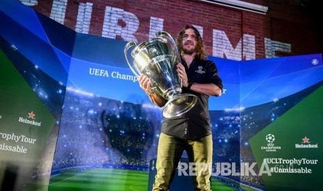 Pesepak bola legenda FC Barcelona Carles Puyol mengangkat trofi Liga Champion saat mengikuti UEFA Champions League Thropy Tour di Jakarta, Senin (11/3/2019).