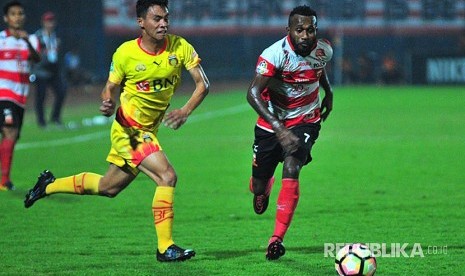 Pesepak bola Madura United FC (MUFC) Engelberd sani (kanan) berebut bola dengan  pesepak bola Bhayangkara FC,  Aslan Sanda (kiri) dalam laga Gojek Traveloka Liga 1 di Stadion Gelora Bangkalan (SGB) Bangkalan, Jawa Timur, Rabu (8/11).