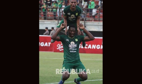 Pesepak bola Persebaya Amido Balde (bawah) melakukan selebrasi bersama Irfan Jaya (atas) usai mencetak gol ke gawang Persela pada pertandingan Liga 1 2019 di Stadion Gelora Bung Tomo, Surabaya, Jawa Timur, Senin (1/7/2019).