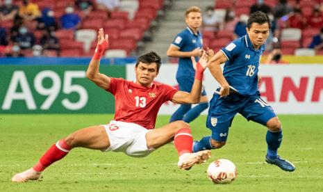 Pesepak bola Timnas Indonesia Rachmat Irianto (kiri) membayangi pergerakan pesepak bola Timnas Thailand Chanatip Songkrasin (kanan) dalam pertandingan Babak Final Leg 2 Piala AFF 2020 di National Stadium, Singapura, Sabtu (1/1/2022).