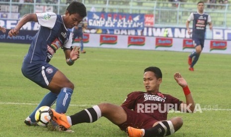 Pesepakbola Arema FC, Dedik Setiawan (kiri) merebut bola dari kaki pesepakbola PSM Makassar, Wasyiat Hasbullah (kanan) dalam pertandingan GOJEK LIGA I di Stadion Kanjuruhan, Malang, Jawa Timur, Ahad (13/5).