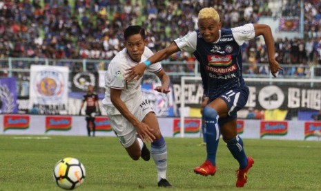 Pesepakbola Arema FC, Rivaldi Bawuo (kanan) dan pesepakbola Persela Lamongan, Ahmad Birrul Walidain (kiri) beradu cepat untuk menjangkau bola dalam pertandingan LIGA I GOJEK di Stadion Kanjuruhan, Malang, Jawa Timur, Sabtu (7/7). 