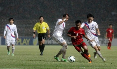    Pesepakbola Indonesia Muhammad Hargianto (merah) berebur bola dengan pemain Korea Selatan dalam laga kualifikasi group G AFC U-19 di Gelora Bung Karno, Senayan, Jakarta, Sabtu (12/10).  (Republika/Yasin Habibi)