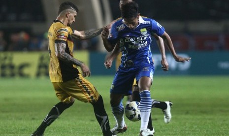 Pesepakbola Persib Bandung Yandi Sofyan (kanan) berebut bola dengan pesepakbola Mitra Kukar Arthur Cunha Da Rocha (kiri) pada laga perdana Liga Bhayangkara di Stadion Si Jalak Harupat,Kabupaten Bandung, Jawa Barat, Kamis (17/3).