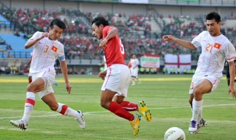 Pesepakbola Timnas Indonesia, Samsul Arif (tengah) dihadang dua pesepakbola timnas Vietnam, Nguyen Minh Duc (kiri) dan Dao Van Phong (kanan) dalam pertandingan persahabatan internasional di Gelora Bung Tomo (GBT) Surabaya, Jatim, Sabtu (15/9)