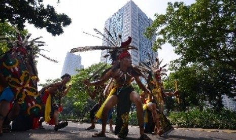 Peserta beraksi dalam Karnaval Budaya Dayak di Jalan Jenderal Sudirman, Jakarta