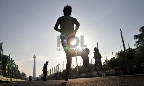  Peserta lomba lari Jakarta International 10K saat menuju garis finish di kawasan silang Monas, Jakarta Pusat, Ahad (23/6).  (Republika/Rakhmawaty La'lang)