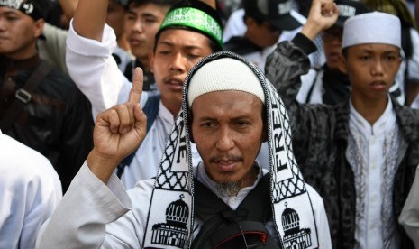 Peserta mengikuti aksi protes pembakaran bendera berkalimat Tauhid di depan Kantor Kemenko Polhukam, Jakarta, Jumat (26/10/18).