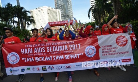 Peserta mengikuti jalan santai dalam rangka peringatan Hari Aids Sedunia yang diselenggarakan oleh Forum LSM Peduli AIDS di Kawasan Bundaran HI Jakarta, Ahad (3/12).