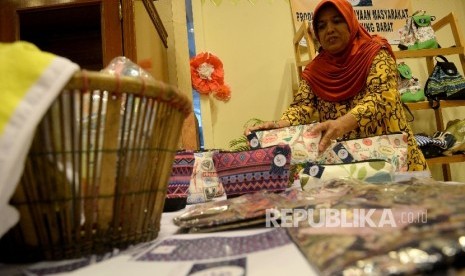 Peserta pameran Ekonomi Kreatif Rusunawa Jakarta (E-Kerja) menata hasil kerajinan ketika mengikuti pameran di Gedung Blok G, Balaikota Jakarta, Rabu (26/4).