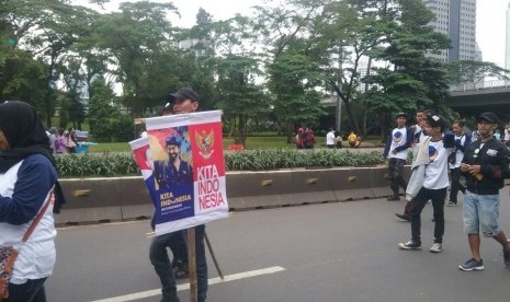 Peserta Parade Kebudayaan mengenakan kaos beratribut partai di Jakarta pada Ahad (4/12).