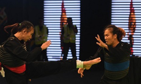 Pesilat putri Indonesia Wewey Wita (kiri) menendang pesilat putri Vietnam Tran Thi Them dalam final tanding kelas B 50-55 Kg putri pencak silat SEA Games XXIX Kuala Lumpur di Stadion Juara, Bukit Kiara, Kuala Lumpur, Malaysia, Selasa (29/8). 