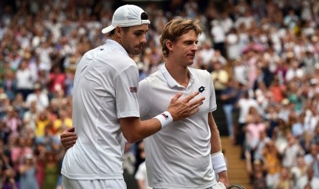 Petenis Afrika Selatan Kevin Anderson (kanan) mendapat ucapan selamat dari petenis AS John Isner dalam pertandingan semifinal di Turnamen Tenis Wimbledon di London, Inggris, Jumat (13/7) waktu setempat