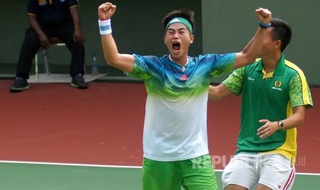  Petenis beregu putra Jatim Anthony Sutanto (kiri) meluapkan kegembiraannya usai mengalahkan lawannya petenis beregu putra Jabar pada final PON XIX