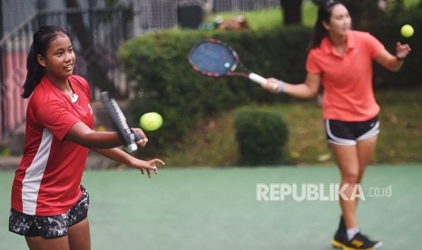 Petenis putri Indonesia Fitriana (kiri) dan Aldila Sutjiadi (kanan) melakukan latihan di Jakarta, Rabu (23/5).