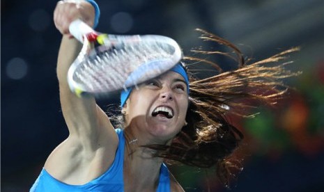 Petenis Rumania, Sorana Cirstea, melepaskan servis saat menghadapi petenis Italia, Roberta Vinci, dalam laga putaran pertama turnamen tenis Dubai Terbuka di Dubai, Uni Emirat Arab, Senin (17/2). 