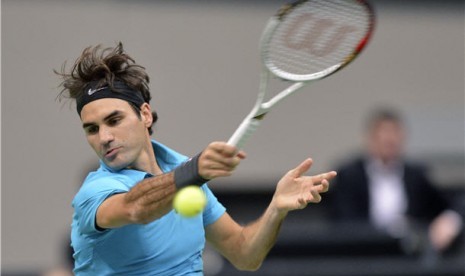 Petenis Swiss, Roger Federer, melepaskan pukulan saat menghadapi petenis tuan rumah, Thiemo De Bakker, di laga turnamen World Indoor di Ahoy Arena, Rotterdam, Belanda, Kamis (14/2). 