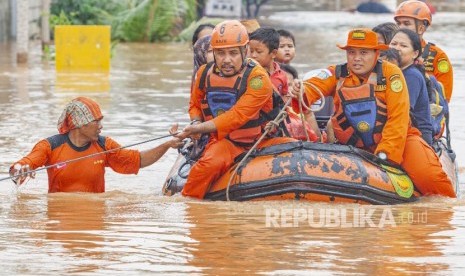 Petugas Basarnas mengevakuasi warga terdampak banjir di Desa Purwasari, Karawang, Jawa Barat, Selasa (25/2). Banjir mengakibatkan sejumlah gardu listrik di Karawang dipadamkan untuk keselamatan warga.