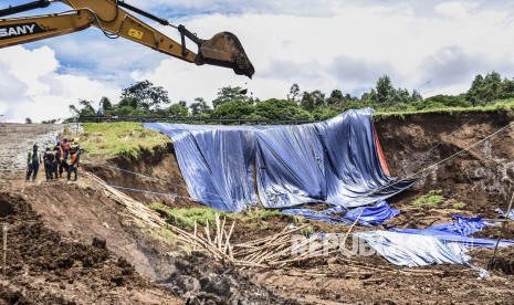 Petugas berada di area pemasangan perkuatan lereng di lokasi pergerakan tanah yang menyebabkan longsor di KM 118 Tol Cipularang, Kabupaten Bandung Barat, Senin (17/2).