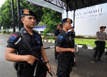 Petugas Brimob berjaga di pintu masuk saat acara KTT Bisnis Asean di Balai Sidang Jakarta, Kamis (5/5).