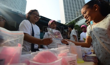   Petugas dari Badan Pengawas Obat dan Makanan (BPOM) menunjukan jenis-jenis makanan yang berbahaya kepada warga yang mengunjungi Car Free Day (CFD) Thamrin, Jakarta, Ahad (13/9). (Republika/Raisan Al Farisi)