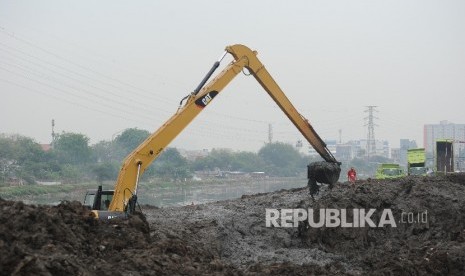 Petugas dengan alat berat mengeruk endapan lumpur di sungai Ciliwung di kawasan Banjir Kanal Barat (BKB), Jakarta, Ahad  (24/9). 