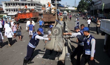  Petugas Dishub memasang pembatas jalan saat penertiban di kawasan Pasar Tanah Abang, Jakarta Pusat, Ahad (11/8). (Republika/ Yasin Habibi)