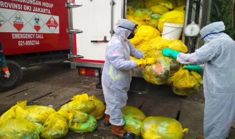 Petugas DLH DKI mengumpulkan masker bekas sekali pakai dari tumpukan sampah rumah tangga untuk dimusnahkan dengan cara diinsinerasi, Jumat (13/11/2020). Yayasan Upakara Persada Nusantara mengajukan kerja sama dengan LPTB LIPI untuk mendaur ulang masker bekas.