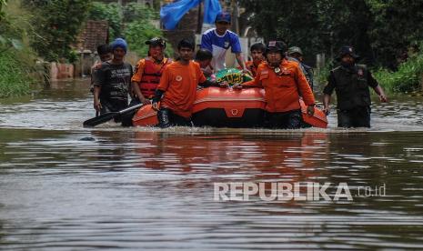 Petugas gabungan mengevakuasi jenazah menggunakan perahu karet di Andir, Baleendah, Kabupaten Bandung, Jawa Barat, Kamis (1/4/2021). Petugas gabungan dari BPBD, Pemadam Kebakaran, dan Tagana membantu mengevakuasi jenazah anggota keluarga yang meninggal dunia di permukiman yang terdampak banjir luapan Sungai Citarum.