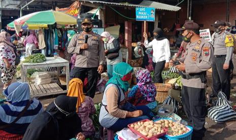 Petugas gabungan Polsek dan Koramil Tengaran melaksanakan edukasi dan sosialisasi sekaligus pembagian masker kepada masyarakat yang beraktifitas di Pasar Kembangsari, Kecamatan Tengah, Kabupaten Semarang, Senin (8/3). Kepatuhan warga pasar untuk menegakkan disiplin pemakaian masker dalam mencegah munculnya klaster pasar tradisional masih harus didorong.