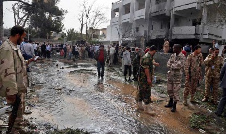  Petugas keamanan memeriksa lokasi bom mobil yang  menargetkan Kedubes Prancis di Tripoli, Libya, Selasa (23/4).    (AP/Abdul Majeed Forjani)