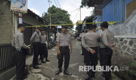 Petugas Kepolisian bergaja saat melakukan memeriksa dan menggeledah sebuah rumah terduga teroris oleh tim Densus 88 di Kampung Paledang, Kecamatan Cileunyi, Kabupaten Bandung, Selasa (6/6).