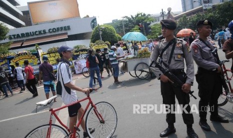  Petugas kepolisian berjaga di lokasi serangan teror , saat hari bebas kendaraan bermotor di Jalan MH Thamrin, Jakarta, Ahad (17/1). (Republika/Agung Supriyanto)