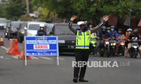 Petugas Kepolisian melarang pengendara mobil berplat nomor genap untuk masuk ke jalan RA Kartini saat uji coba ganjil genap di Kota Cirebon, Jawa Barat, Jumat (13/8/2021). Pemkot Cirebon menerapkan sistem ganjil genap di delapan ruas jalan di kota pada pukul 13.00-17.00 WIB untuk mengendalikan mobilitas warga sebagai upaya menurunkan angka penyebaran COVID-19. 