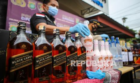 Petugas kepolisian menata barang bukti saat rilis kasus minuman keras (miras).