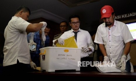 Petugas kepolisian menujukan barang bukti terkait Operasi Tangkap Tangan (OTT) di Kementerian Perhubungan (Kemenhub), Jakarta,Rabu (12/10).