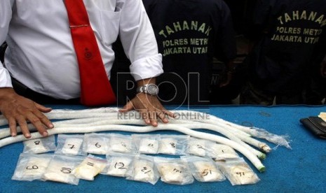  Petugas Kepolisian Polres Jakarta Utara menunjukkan barang bukti narkotika jenis Sabu dan dua orang tersangka saat rilis barang bukti di Polres Jakarta Utara, Senin (27/5).    (Republika/ Yasin Habibi)