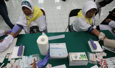 Ketum PERDOKHI: Pembinaan Kesehatan Haji Perlu Inovasi. Foto: Petugas kesehatan mengambil darah calon haji untuk dites, di Asrama Haji Embarkasi Surabaya, di Surabaya, Jawa Timur, Sabtu (6/7/2019).